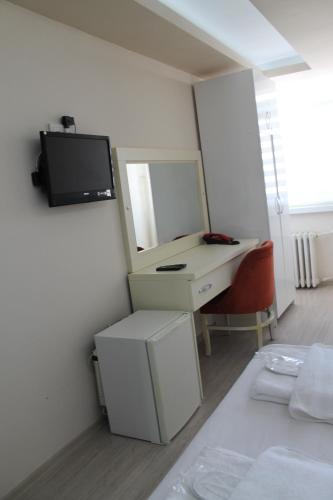 a bathroom with a mirror and a sink at Hotel Abro Necatibey in Ankara