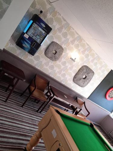 a gaming room with a pool table and a cell phone at The Avenue Club and Lodge in Birmingham