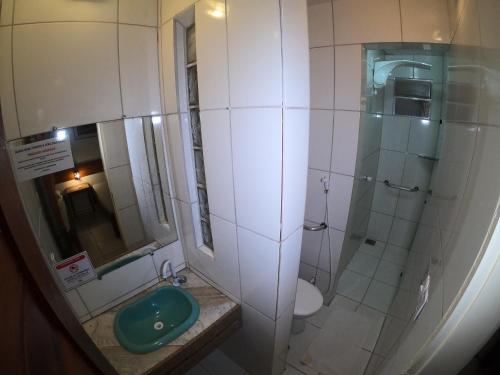 a bathroom with a shower and a sink and a toilet at Pousada Casa Do Angelo in Jericoacoara