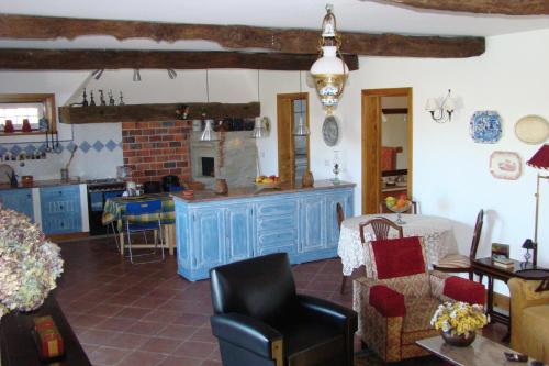 a kitchen with a blue island in a room at Casa Da Oliveirinha in Casco