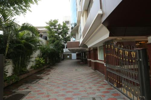 an empty alley with a fence next to a building at Hotel Ashok Residency in Chennai