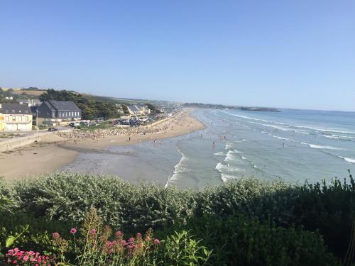 a view of a beach with people in the ocean at Villa plaisance in Plomodiern