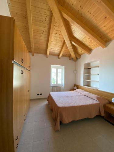 a bedroom with a bed and a wooden ceiling at Residence Riviera in Albenga