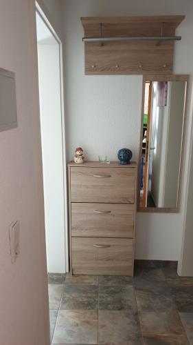 a bedroom with a dresser and a mirror at Ferienwohnung auf dem Bückle in Kleines Wiesental