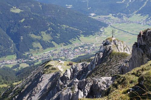 a cross on the top of a mountain at Am Sonnenfels in Lermoos