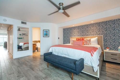 a bedroom with a large bed with a blue accent wall at Villa Nautilus St. Thomas in East End