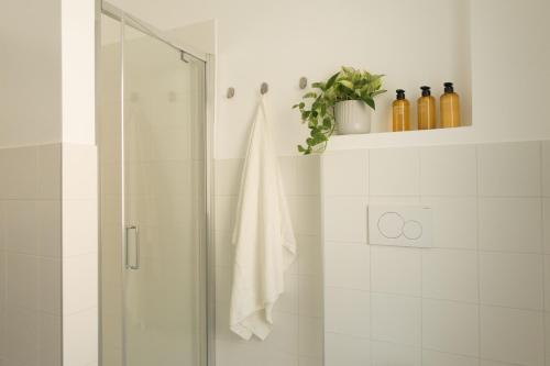 a bathroom with a shower with a glass door at Da Coco - Rooms in Padova