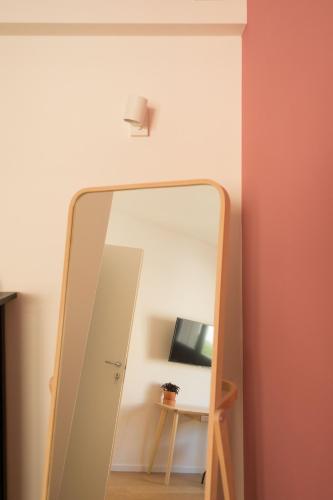 a large mirror in a room with a table at Da Coco - Rooms in Padova