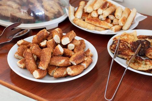 a wooden table with plates of food on it at Hotel Pelit in Canakkale