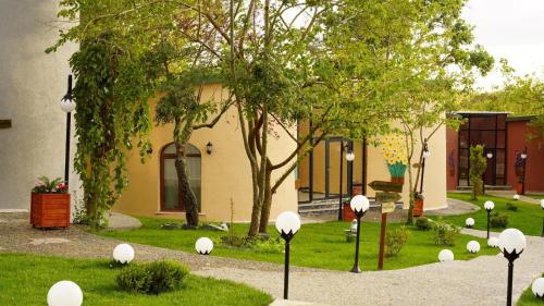 a garden with white balls in the grass at Kule Hotel Airport in Arnavutköy