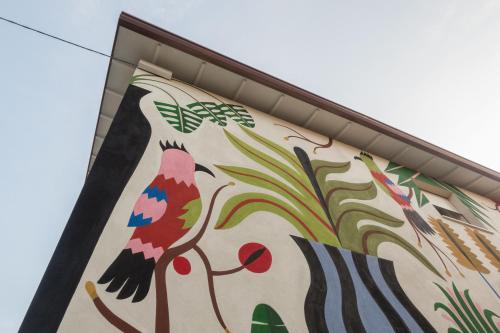 a building with a painting of birds on it at Da Coco - Rooms in Padova