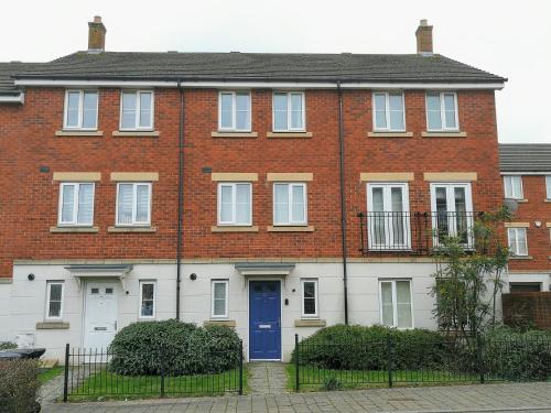 a red brick house with a blue door at Comfortable and Welcoming Beatrix House by Cliftonvalley Apartments in Bristol