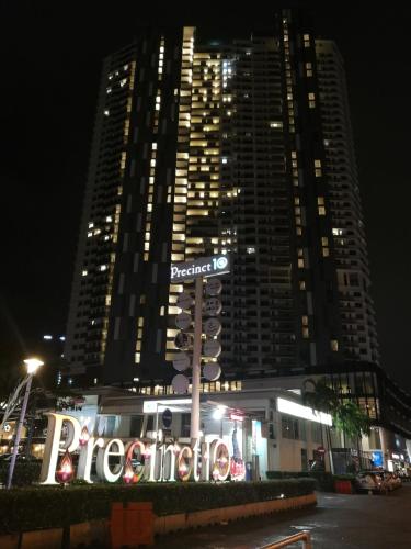 a traffic light in front of a large building at night at Landmark Lovely Coast View King Suite#500mbpsWifi#Netflix in Tanjong Tokong