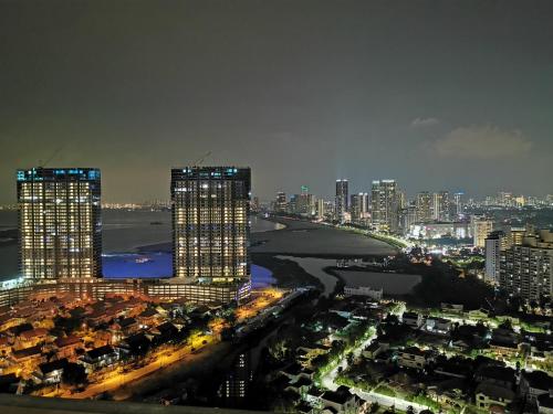 a city skyline at night with tall buildings at Landmark Lovely Coast View King Suite#500mbpsWifi#Netflix in Tanjong Tokong