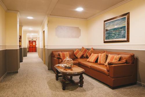 a living room with a couch and a table at Hotel Corallo in La Spezia