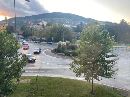 a street with cars parked in a parking lot at Apartman "Amy Delux" in Zenica