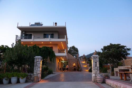 a house with a pathway leading up to it at Tsoutsis Apartments in Marantochori