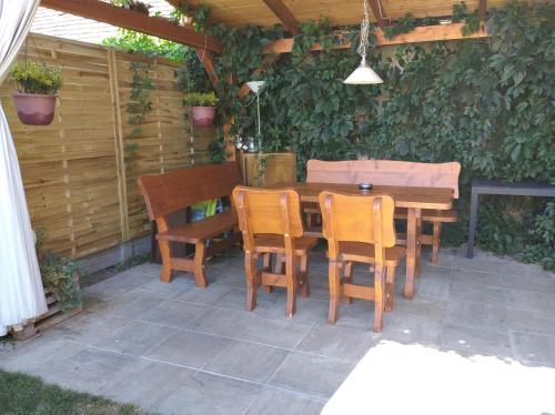 Una mesa y sillas de madera en un patio. en Ubytování v soukromí Opolany u Poděbrad, en Opolany