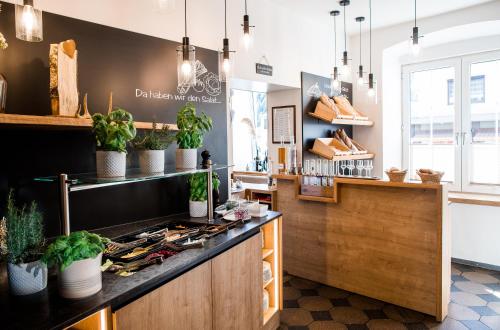 a kitchen with a counter with potted plants at Wallner - Hotel & Wirt in Arnoldstein