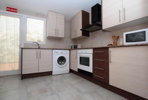 a kitchen with a washing machine and a dishwasher at Casa Rural Bekirent in Bocairent