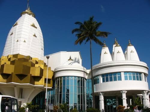 a building with a palm tree in front of it at Sancta Maria 10 - Ultimate in luxury & majestic sea views includes private entertainment deck - Free wifi in Kingsburgh