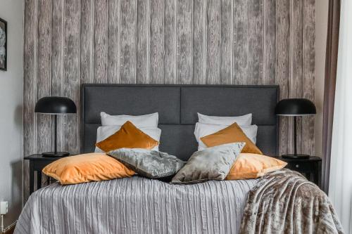 a bedroom with a bed with pillows on it at Ludvika Stadshotell in Ludvika