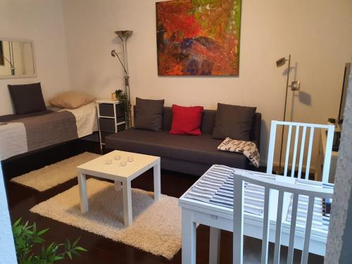 a living room with a couch and a table at HomeAway City in Kuopio