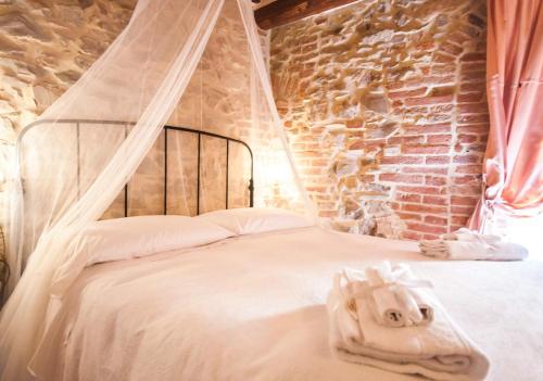 a bedroom with a bed with a canopy at B&B Antica Gabella in Castiglione del Lago