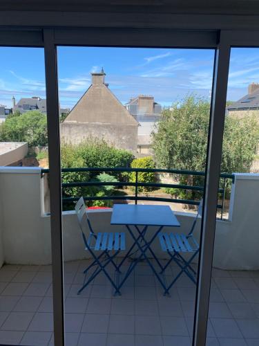 une table et deux chaises sur un balcon dans l'établissement 65 m2 Centre vannes 2 ch wifi parking, à Vannes
