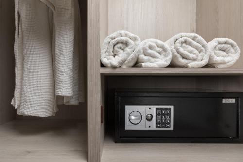 a microwave oven with two pretzels on a shelf at Melina Oasis Boutique Hotel in Kassiopi