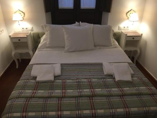 a bedroom with a large bed with two night stands at SunShine La Hoguera in Córdoba