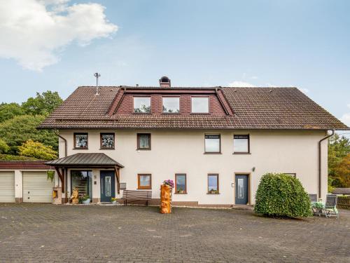 a large white house with a roof at Vacation home with garden in beautiful Sauerland in Kirchhundem