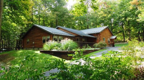 a log cabin in the middle of a forest at Sojourner's Lodge & Log Cabin Suites in Dundee