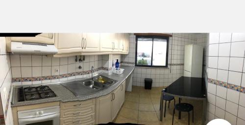a small kitchen with a sink and a stove at Wonderful apartament Lisbon in Montijo