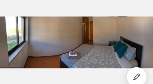 a bedroom with a bed with a book on it at Wonderful apartament Lisbon in Montijo