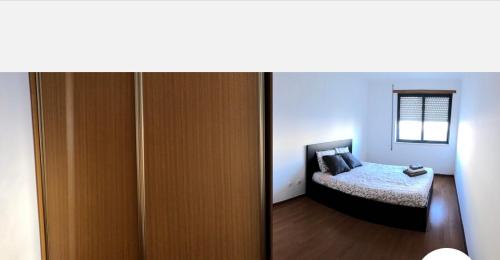 sypialnia z łóżkiem i drewnianymi drzwiami w obiekcie Wonderful apartament Lisbon w mieście Montijo