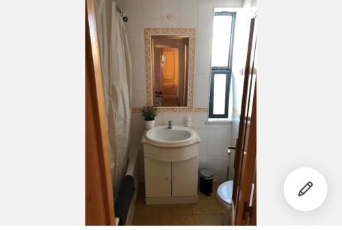 a bathroom with a sink and a mirror at Wonderful apartament Lisbon in Montijo