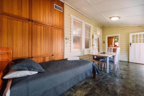 a bedroom with a bed and a table with chairs at Fitzroy Motor Inn in Grafton