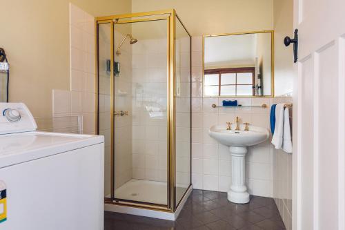 a bathroom with a shower and a sink at Fitzroy Motor Inn in Grafton