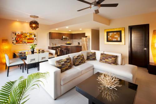 a living room with a white couch and a table at The Fives Beach Hotel & Residences - All Senses Inclusive in Playa del Carmen