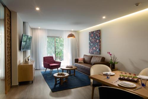 uma sala de estar com um sofá e uma mesa em The Fives Beach Hotel & Residences - All Senses Inclusive em Playa del Carmen