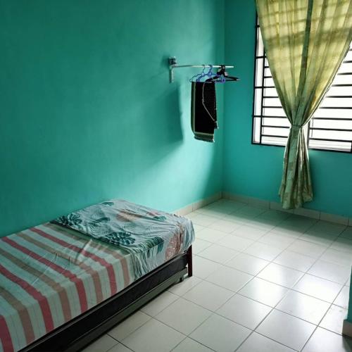 a blue room with a bed and a window at Ms Homestay jeli in Jeli