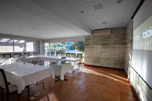 a conference room with white tables and chairs at Atalaia in Irún