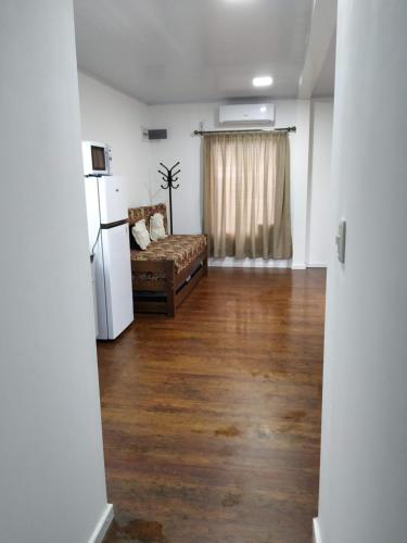 a living room with a couch and a refrigerator at Posada La Nona in Minas