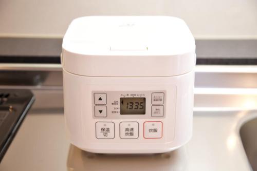 an alarm clock sitting on top of a table at Vent du Vent302 in Minatogawa