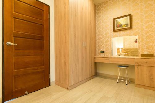 a room with a wooden door and a vanity with a stool at D3 Classic BNB in Wujie