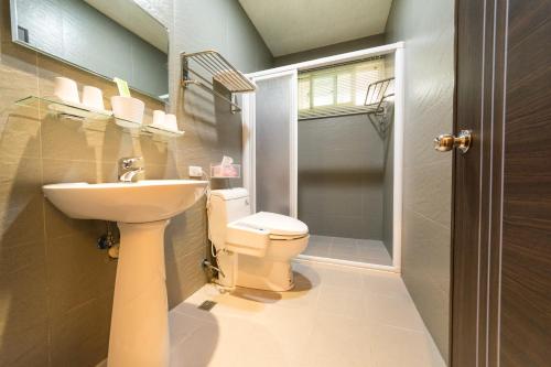 a bathroom with a toilet and a sink at D3 Classic BNB in Wujie