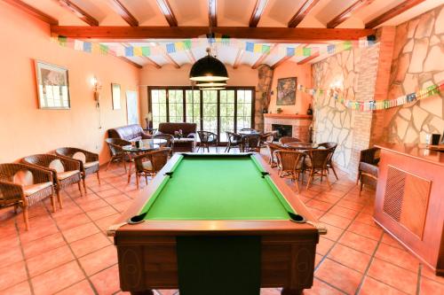 a pool table in the middle of a room at Hotel Rural Serrella in Castell de Castells