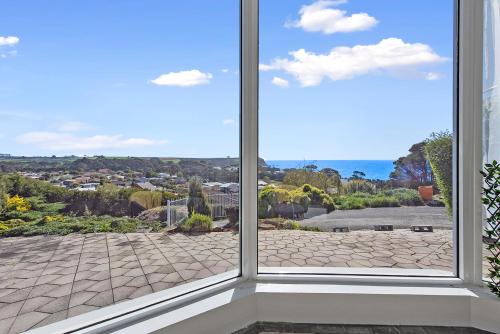 a window with a view of a city at Views Forever - Devonport in Devonport