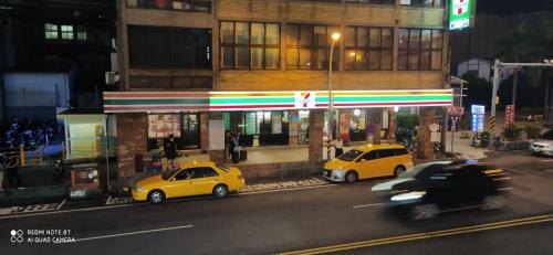 two cars parked in front of a gas station at night at EasyLiving in Tainan